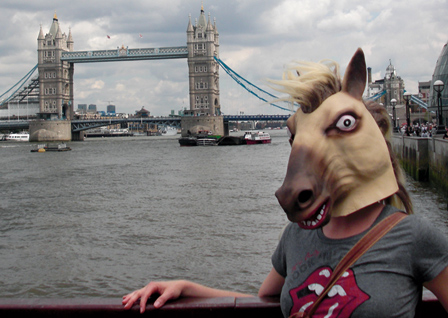 © Katrin Geistler junge frau mit pferdekopfmaske lehnt an einem gelaender - im hintergrund die towerbridge in london