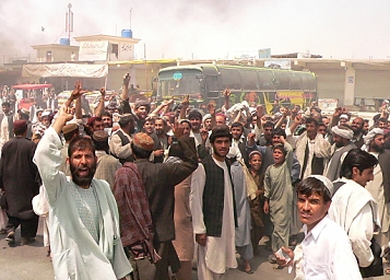 © EPA Afghans shout slogans during a protest against the alleged firing of NATO's soldiers on a civilian bus, in Kandahar.