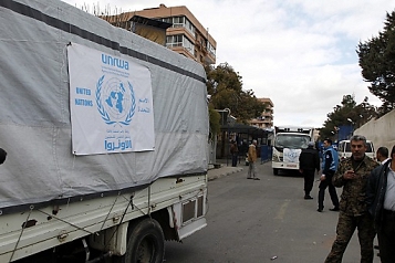 © EPA/STR a convoy of UNRWA aid trucks
