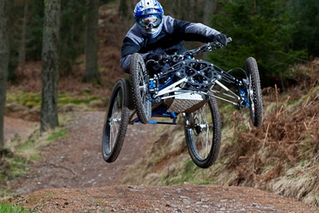 a man jumps down a downhill track on his wheel chair