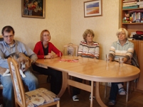 Tisch mit vier Personen und einem Hund