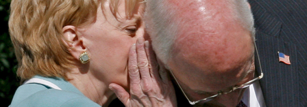 Lynne Cheney whispers in the ear of her husband Vice President Dick Cheney 