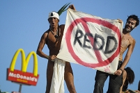 Members of environmentalist groups with banner: REDD