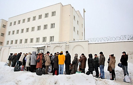 Relatives and friends of arrested Belarussian opposition supporters wait outside the prison walls to bring food and clothes