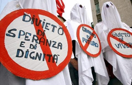 Demonstrater sporting sign reading "No hope and dignity", "No future" and "No life" attend the "MayDay Parade" organised in downtown Milan on Monday 01 May 2006 by leftist organizations and movements