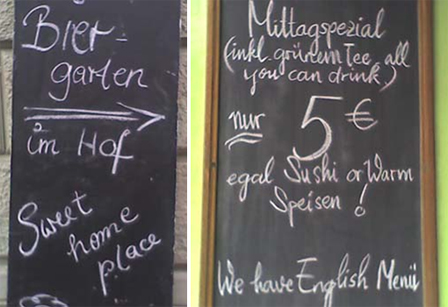 Tafeln von Restaurants. Einmal mit: "Sweet home place", ein andermal: "Mittagspezial (inkl. grünem Tee all you can drink) nur 5 Euro, egal Sushi or Warm Speisen! We have English Menü"