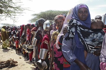 Newly arrived Somali refugees who had fled the drought wait in line to receive emergency food in Mogadishu, Somalia