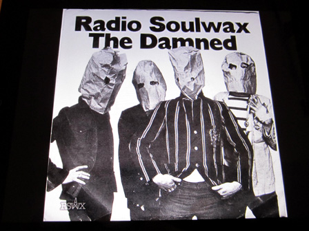 Ein eingescanntes Cover aus einem "Radio Soulwax"-Mix. Man sieht vier Männer mit Papiersäcken über den Köpfen, darüber steht geschrieben "Radio Soulwax", darunter "The Damned".