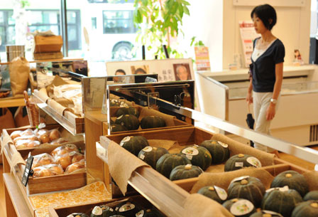 A women looks at vegetables produced in Fukushima 