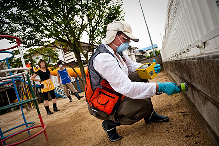 Radiation expert checking for radiation levels at the Minami kindergarten in Fukushima