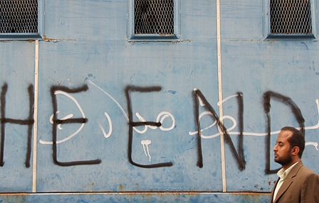 Ägytischer Mann vor einem Gebäude mit dem Graffiti "The End"