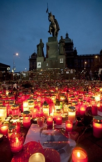  A poster of late Czech president Vaclav Havel seen among lit candles in front of the statue of St. Venceslas on the Venceslav Square in downtown Prague on 22 December 2011