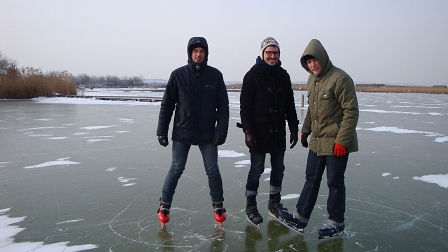 Max, Julian und Tom von Garish mit Schlittschuhen am Eis