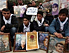 Palestinians hold pictures of their relatives held by Israel in "administrative detention" in a protest in support of hunger striker, Khader Adnan