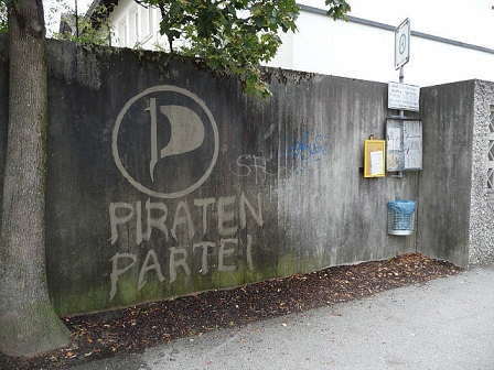 Mauer, auf die das Logo der deutschen Piratenpartei gesprayt wurde