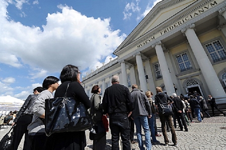  People stand in line in front of the Museum Fridericianum in Kassel, Germany