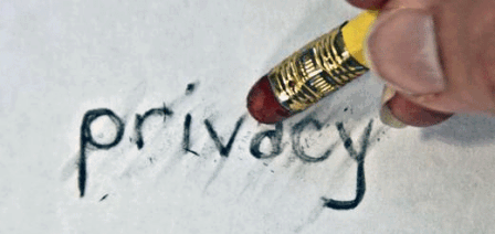 Aufschrift "privacy" auf einem Blatt Papier und ein Radiergummi, der sie wegradiert