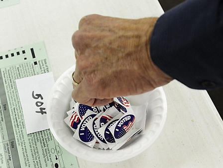 A voter picks up a sticker after voting at a polling site in the 2012 US presidential election 