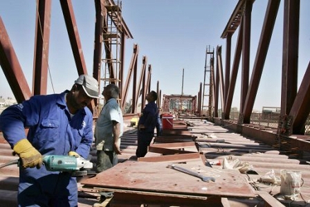 Iraqi builders during the reconstruction of al-Sarafiya bridge in Baghdad