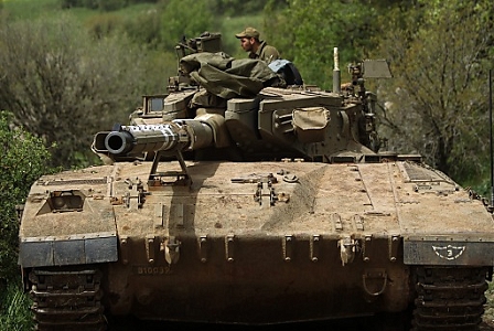 An Israeli tank is seen at the Israeli-Syrian border in the Golan Heights, 08 April 2013