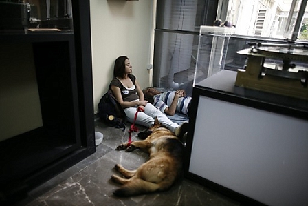 Two employees of the Greek state television ERT take a nap in one of the offices at the broadcasting station headquarters in Agia Paraskevi after the government announced ERT's closure
