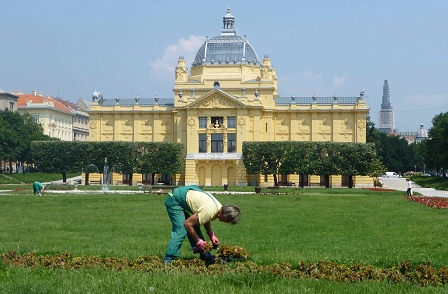 a man gardening in front of Croatian parliament