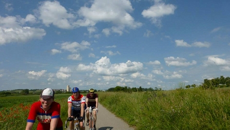 cycling through the countryside in vintage clothes