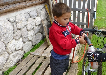 a little boy hands out water at the Sella Ronda