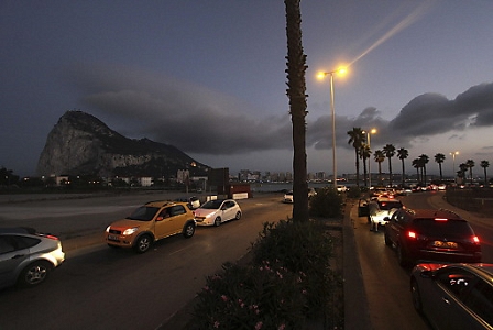 Vehicles wait in a more than two hour-long queue in order to enter Gibraltar (background L) on at La Linea de la Concepcion, Southern Spain, 11 August 2013