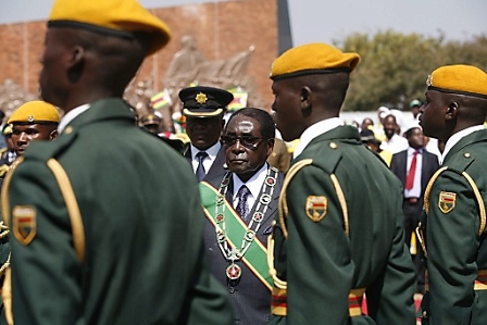 Zimbabwean President Robert Mugabe (C) inspects a guard of honor at the National Heroes Acre to commemorate Heroes Day in the capital Harare, Zimbabwe, 12 August 2013