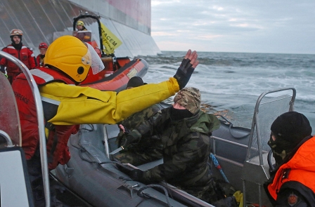 Action Against Gazprom's Arctic Drilling 
A Russian Coast guard officer is seen pointing a gun at a Greenpeace International activist 