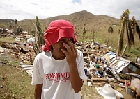 A Filipino looks at the destruction in the outskirts of the super typhoon devastated city of Tacloban