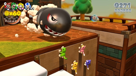 Ein Bildschirmfoto aus dem Videospiel "Super Mario 3D World", wo die vier Spielfiguren im Katzenkostüm auf eine Plattform klettern, auf der eine übergroße Kanonenkugel wartet.