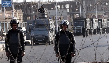 © EPA/KHALED ELFIQI Egyptian riot police outside the police academy in Cairo
