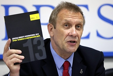 Sergei Nikitin, Director of Amnesty International's Moscow Office, shows journalists a copy of Amnesty International Report 2013 on human rights 