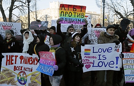 Supporters of the LGBT (Lesbian, Gay, Bisexual and Transgender) and sexual minorities hold poster 'LGBT against fascism' as they attend in attend a anti-fascist rally in Moscow 19 January 2014