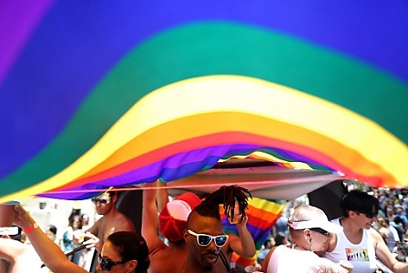 Dancing under a rainbow flag.