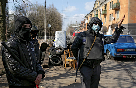 Pro-Russian protesters man a checkpoint on a road in Slaviansk, Ukraine, 15 April 2014