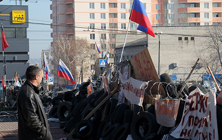 A man stands by a barricade near the occupied by pro-Russian activists security service building in Lugansk, Ukraine, 15 April 2014. 