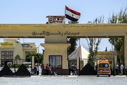 An Egyptian ambulance waits to take Palestinians wounded in the ongoing offensive against the Gaza Strip, at the border crossing of Rafah, Egypt.