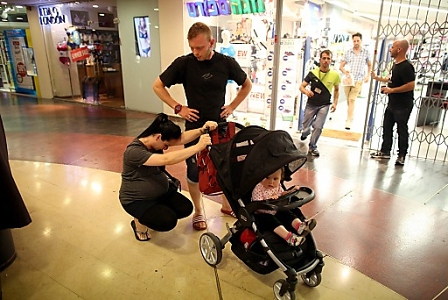 A pregnant woman puts her head down as she takes cover in the Tel Aviv main shopping mall, as a multiple warning siren from incoming rockets sound around city of Tel Aviv, Israel