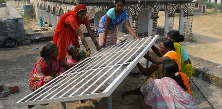 Women installing a solar panel