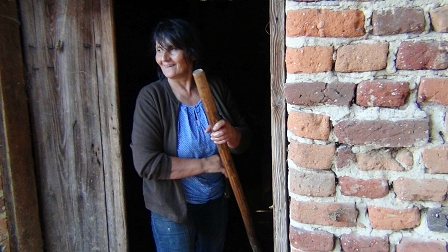 Maria outside her cowshed