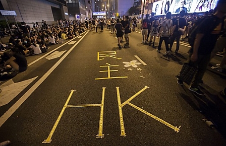 ^Democracy Hong Kong' is seen marked on the road on the second day of the mass civil disobedience campaign Occupy Central, Central District