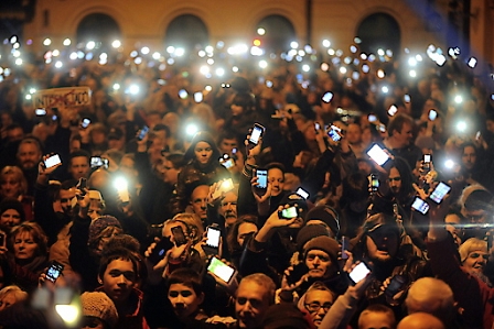 Thousands of demonstrators light up their mobile phones as they protest against an internet tax planned to be introduced by the Hungarian government