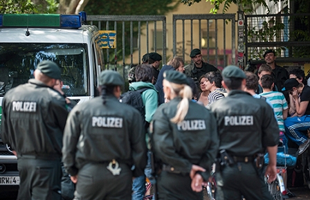 Supporters of the refugees and police stand in front of former Gerhart-Hauptmann school in the Kreuzberg neighbourhood of Berlin, Germany, 03 July 2014.