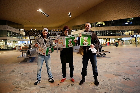 People read the French satirical weekly Charlie Hebdo survivors' issue, on the central train station of Rotterdam in The Netherlands, 16 January 2015