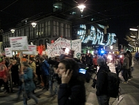 Demozug "Fasching gegen Faschismus" Ecke Kunsthaus Graz, das noch Lichtinstallation "Nous sommes Charlie" zeigt