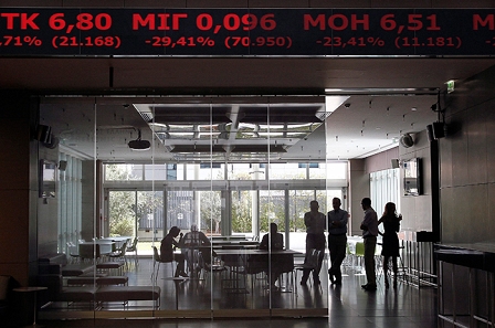 Employees of the Athens Stock Exghange Market stand together under an electronic board diplaying share prices at the Stock Exchange in Athens, Greece, 03 August 2015. 