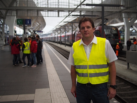 Rene Zumtobel in grellgelber Weste am Bahnsteig
